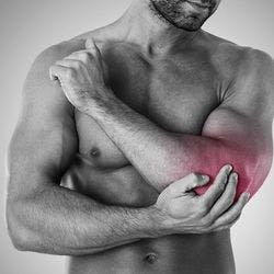 A muscular man experiencing inflammation and discomfort in his elbow.  