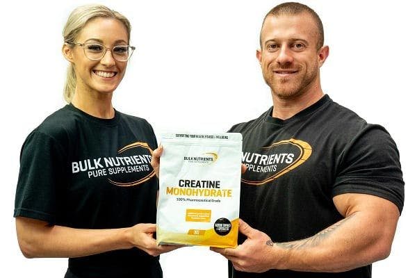Bulk Ambassadors Helena Sly and James Newcombe holding a 1 kg pouch of Bulk Nutrient's Creatine Monohydrate. With proven results, Creatine Monohydrate offers great value and can help users gain strength and increase muscle volume, available in 250g and 1kg pouches.