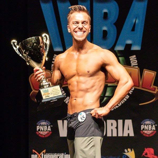 Bulk Ambassador Trent Baynes with a smile from ear to ear on stage has he wins 1st place at the INCA VIC men's fitness division. 