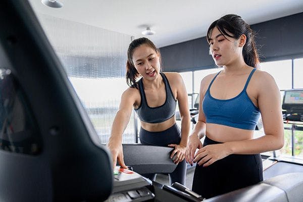 Woman warming down on a treadmill